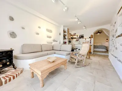 a living room with a couch and a table at Mountain Bliss Guesthouse 2 next to Sougia in Agrilés
