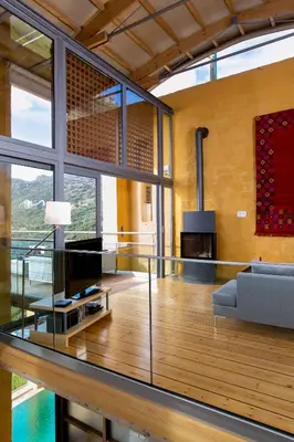 a living room with a glass table and a couch at Seafront Ravdoucha Epavlis Athina Villa - Pool, Gym, Sauna, Private Parking, WiFi in Ravdhoúkha