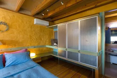 a bedroom with a bed and a glass cabinet at Seafront Ravdoucha Epavlis Athina Villa - Pool, Gym, Sauna, Private Parking, WiFi in Ravdhoúkha