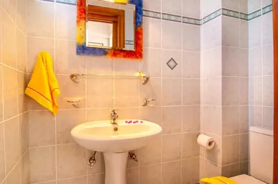 a bathroom with a sink and a mirror at Villa Marianna in Vryses