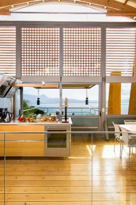 a kitchen with a large window with a view of the ocean at Beachfront Ravdoucha Epavlis Eleni Villa - Pool, Hot Tub, Gym, Sauna, Private Parking, WiFi in Chania Town