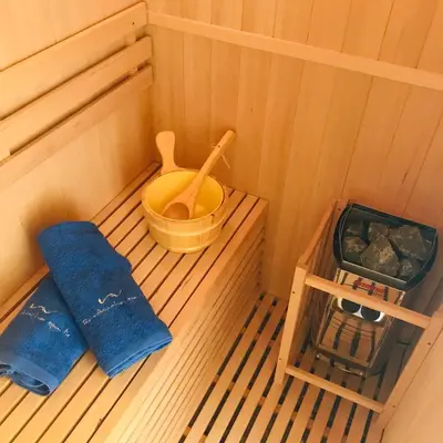 a inside of a sauna with a wooden bowl and a bucket at Beachfront Ravdoucha Epavlis Eleni Villa - Pool, Hot Tub, Gym, Sauna, Private Parking, WiFi in Chania Town