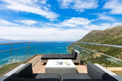 a balcony with a view of the ocean at Beachfront Ravdoucha Epavlis Eleni Villa - Pool, Hot Tub, Gym, Sauna, Private Parking, WiFi in Chania Town
