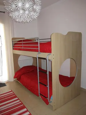 a bunk bed in a room with a chandelier at Villa Pandora - Angela & Michali in Maleme