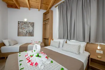 a bedroom with two beds with a dress on the bed at DELUXE MAISONETTE in Chania Town