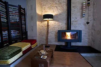 a living room with a television and a fireplace at Athermigo Boutique Estate in Gavalochori