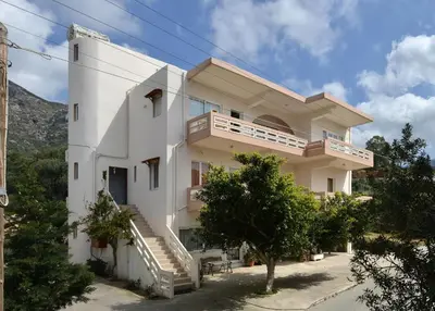 a large white building with stairs on it at Niriida in Sfinárion