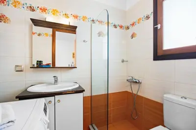 a bathroom with a sink and a shower at Emmanouel Maisonette near the Sea in Parigoría