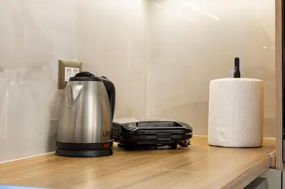 a coffee maker on a counter next to a roll of paper towels at Chris and Stratos villa with private ecologic pool and kid's playground! in Mourniaí