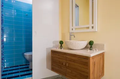 a bathroom with a sink and a toilet and blue tiles at Penelopi Rooms in Chania Town