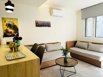 a living room with a couch and a table at Matina Room in Chania Town