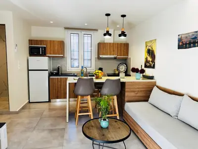 a kitchen and living room with a couch and a table at Matina Room in Chania Town