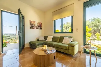 a living room with a couch and a table at Villa Nimertis in Xirokámbion