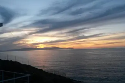 a sunset over a body of water with the sky at Seascape in Tersanas