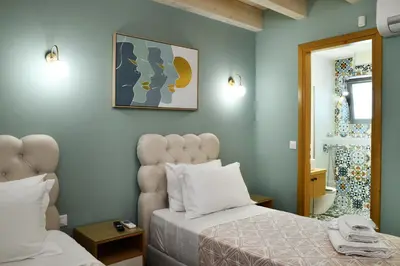 a bedroom with a bed and a mirror at Alexandras's Mansion in Ayiá