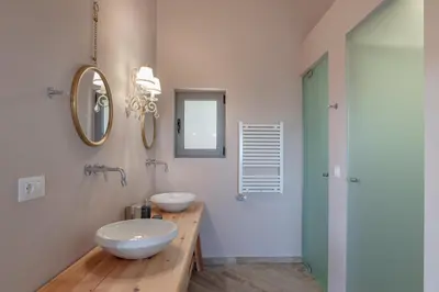 a bathroom with two sinks and a mirror at Alexandras's Mansion in Ayiá