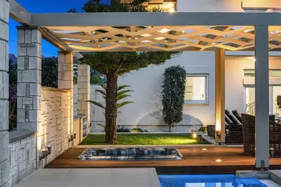 a backyard with a pool and a pergola at Villa Elvina in Kissamos