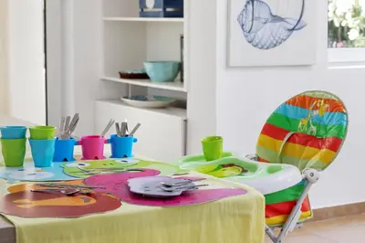 a table with a colorful table cloth and a chair at Villa Elvina in Kissamos