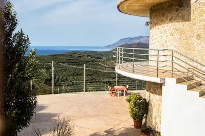 a balcony of a house with a view of the ocean at Rokka Pyrgos Amazing View - Maistros in Rókka