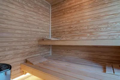 a sauna with wooden walls and wooden shelves at Alexandras's Mansion - Alexinia's House in Ayiá