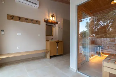 a bathroom with a glass door and a sink at Alexandras's Mansion - Fragkia's House in Ayiá