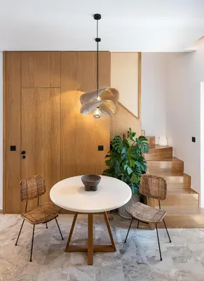 a table and chairs in a room with a staircase at Domi Luxury Apartment by Cura Villas Collection in Chania Town