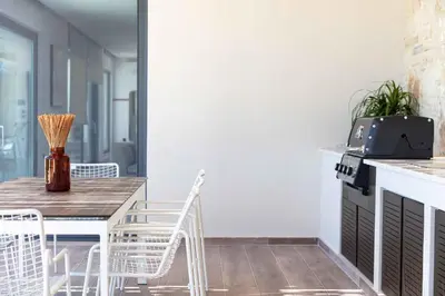 a kitchen with a table and chairs and a stove at Villa Aglaea I Saltwater Pool & Amazing Seaview! in Chania Town