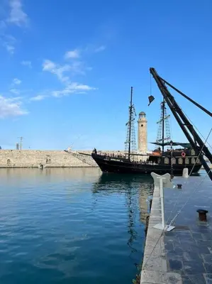 a boat sitting in the water next to a dock at Carlas House, Kalyves in Tsivarás