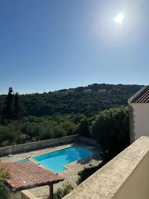 a swimming pool on the side of a house at Carlas House, Kalyves in Tsivarás