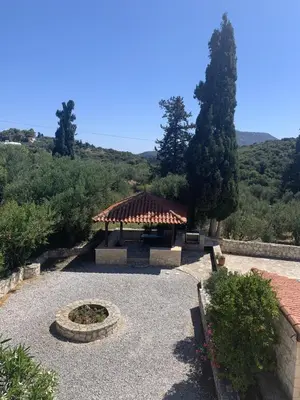 a garden with a gazebo and a fire pit at Carlas House, Kalyves in Tsivarás