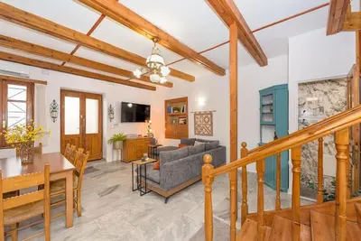 a living room with a staircase and a dining room at Yiayia's Place in Chania in Chania Town