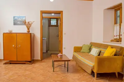 a living room with a couch and a table at Traditional house in Fres in Karés