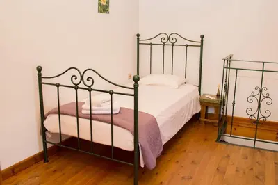 a bedroom with a bed with a metal frame at Traditional house in Fres in Karés