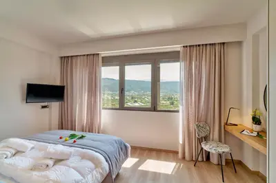 a bedroom with a bed and a large window at Thearia villa I - seaview , private heated pool & jacuzzi in Souda