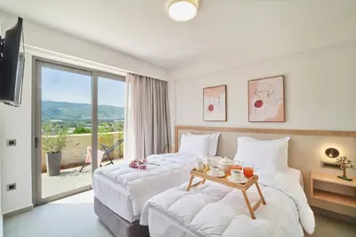 a hotel room with two beds and a balcony at Thearia villa I - seaview , private heated pool & jacuzzi in Souda
