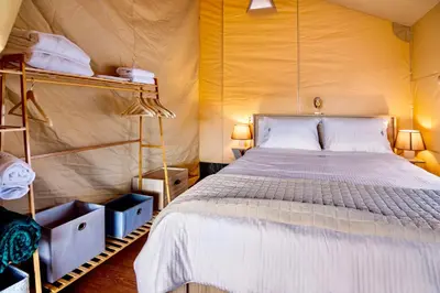 a bedroom with a large bed in a tent at Civara Chalet - Private Glamping in nature with Jacuzzi in Tsivarás