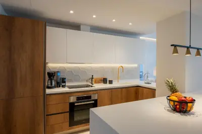 a kitchen with a bowl of fruit on a counter at AmphiMatrion Luxury Residence in Kalyves