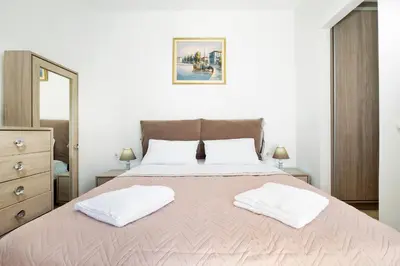a bedroom with a large bed with two white pillows at Villa Idyllic in Maleme