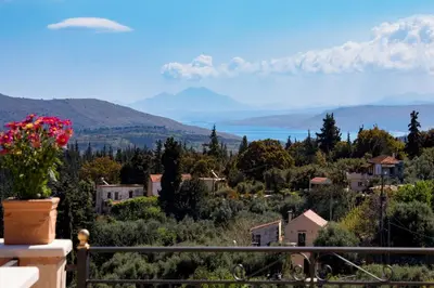 a view of a town with mountains in the background at Villa Kois by PosarelliVillas in Tzitzifés