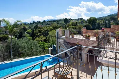 a balcony with a swimming pool on top of a building at Villa Kois by PosarelliVillas in Tzitzifés