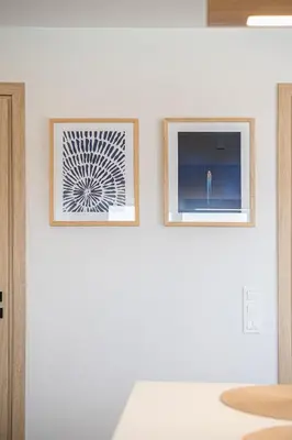 two framed photographs on a wall in a room at Melanthia Villas in Tsivarás