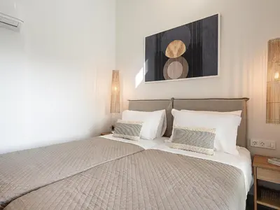 a bedroom with a large bed with two pillows at Melanthia Villas in Tsivarás