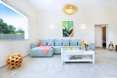 a living room with a blue couch and a table at Villa Avo in Chania Town
