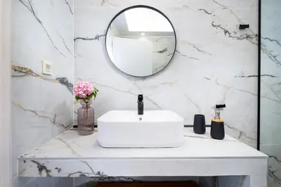 a bathroom with a white sink and a mirror at Villa Avo in Chania Town