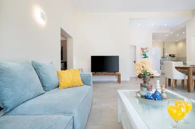 a living room with a blue couch and a table at Villa Avo in Chania Town