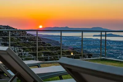 a view of the sunset from a balcony at Apartment Lia with private eco pool - Amazing view in Chania Town