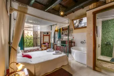 a bedroom with a bed and a bath tub and a tub at IFIGENIA TRAD.ROOMS IN OLDTOWN BY.MARIOS in Chania Town