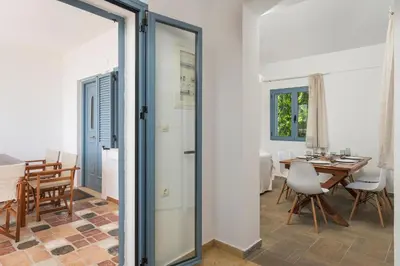 a door leading into a dining room with a table at Seaview Villa Prima, Sea & Sun Villas in Chorafakia