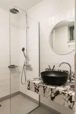 a bathroom with a black sink and a shower at 2 sea view Villas as 1 by Chania Living Stories in Chania Town