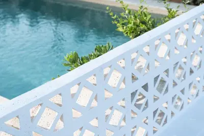 a white fence next to a swimming pool at 2 sea view Villas as 1 by Chania Living Stories in Chania Town